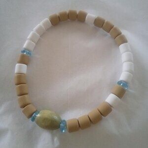 Bracelet...stretch bracelet, center wooden olive color bead, 8.5" inches